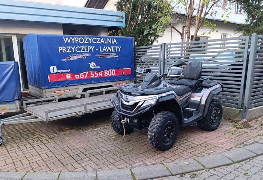 Quad obok przyczepy z plandeką